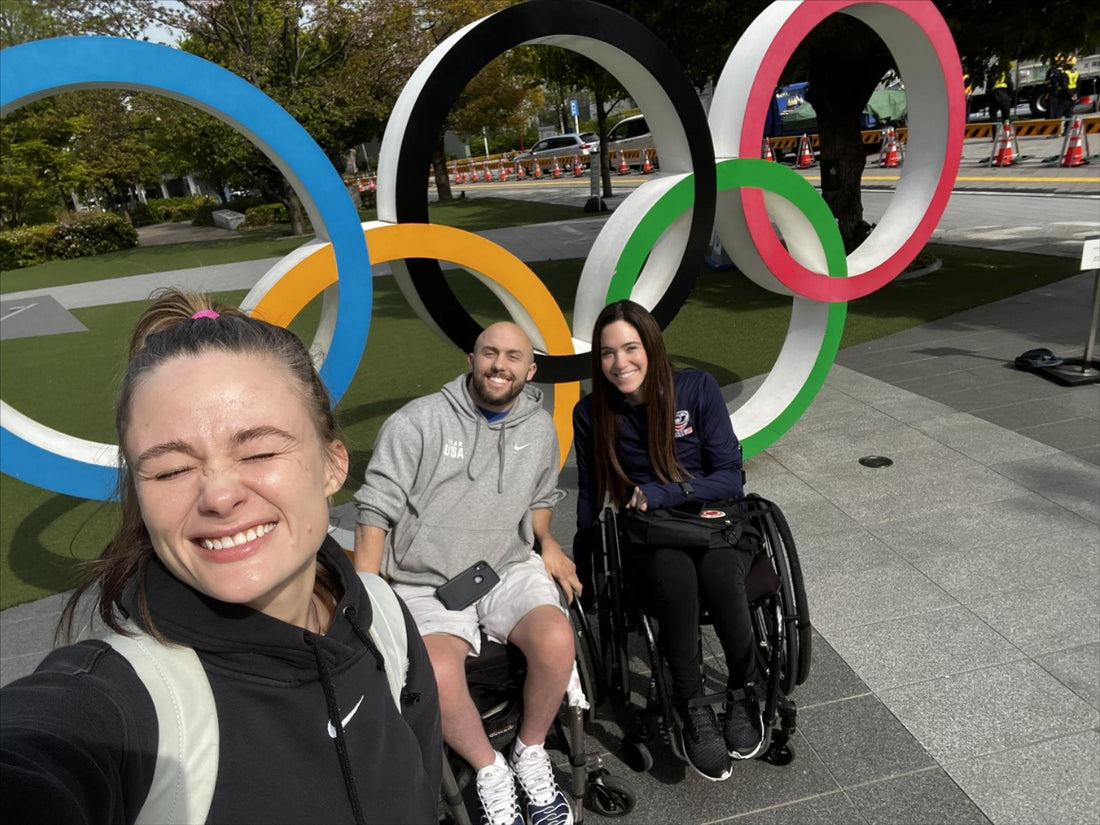 I'm with Mandy and another athlete at the olympic rings in Japan